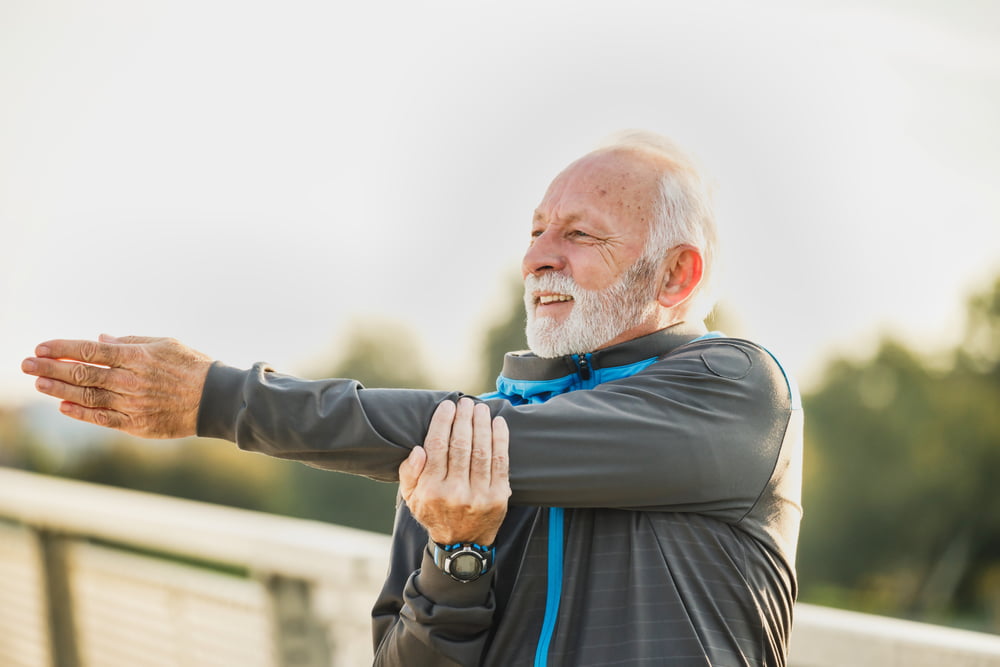 Old man stretching and having a good quality life - Discover How You Can Improve Your Health And Overall Quality Of Life