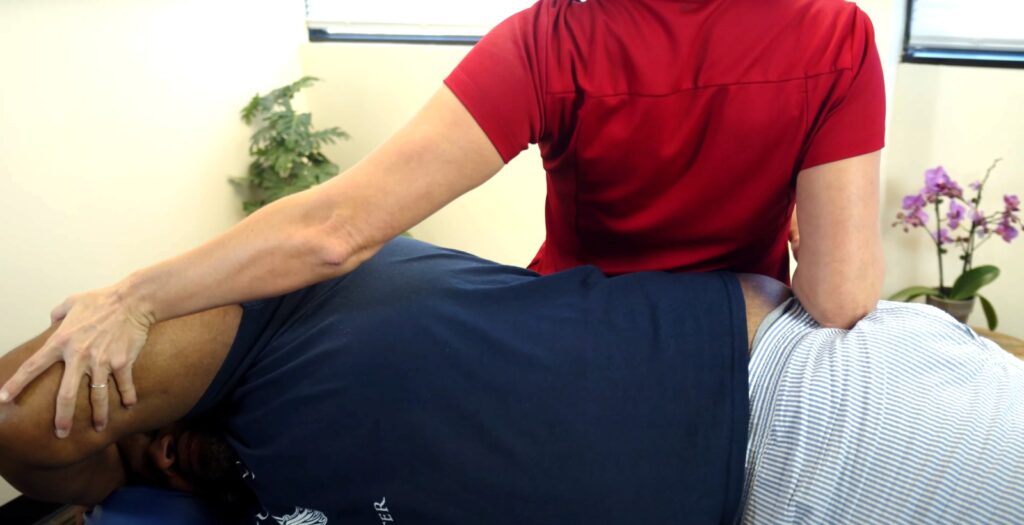 How Fascial Stretch Therapy Can Change Your Life, Lydia stretching a man in Nola stretch and recovery