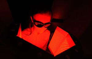 red light therapy in the New Orleans area. The girl goes through a course of skin rejuvenation with the help of red light treatment.
