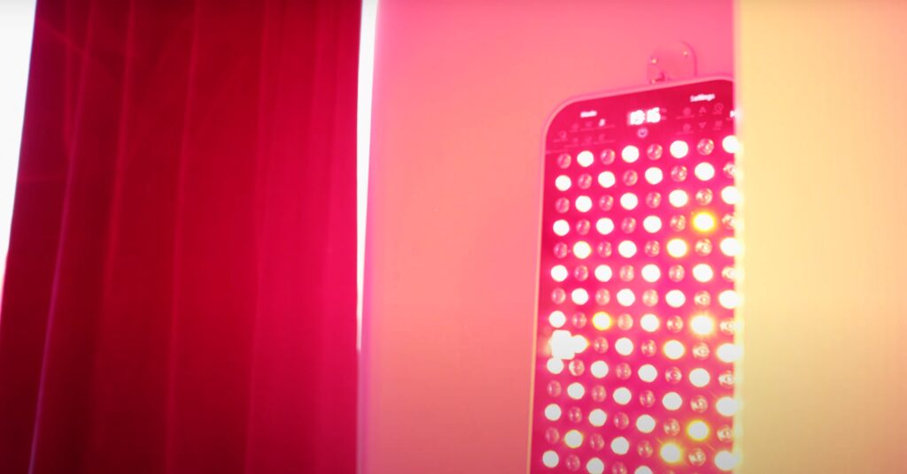 Total Spectrum Red Light Therapy (RLT) panel in New Orleans emitting a bright red glow at the Recovery Room at Nola stretch & recovery